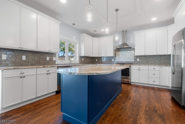 kitchen featuring white cabinetry, wall chimney range hood, dark wood-type flooring, and appliances with stainless steel finishes