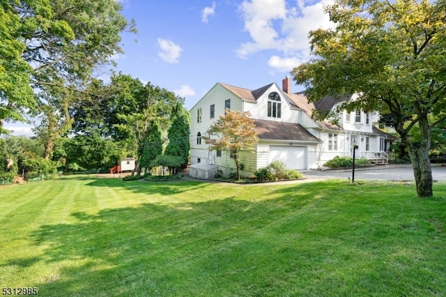 view of side of home with a yard and a garage