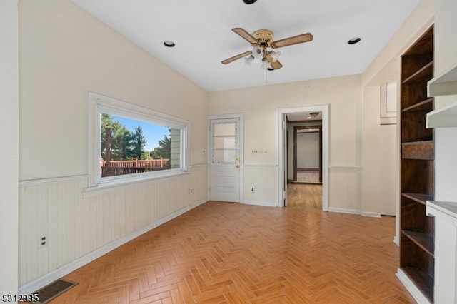 unfurnished room featuring light parquet flooring and ceiling fan