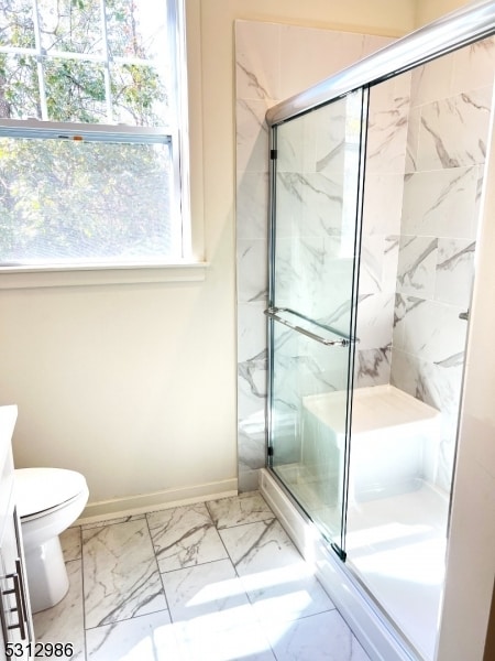 bathroom featuring walk in shower, vanity, and toilet