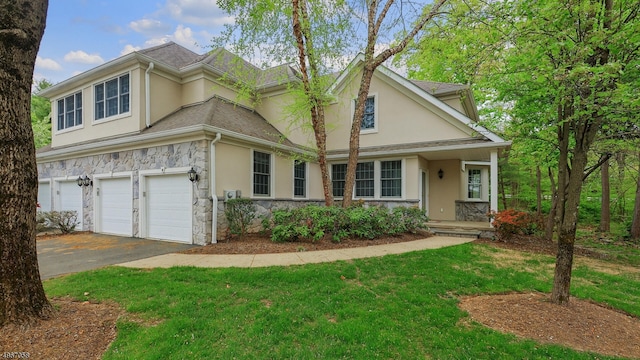 view of front property with a garage and a front lawn