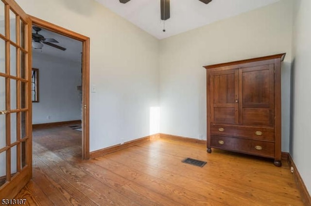 unfurnished bedroom with light hardwood / wood-style floors and ceiling fan