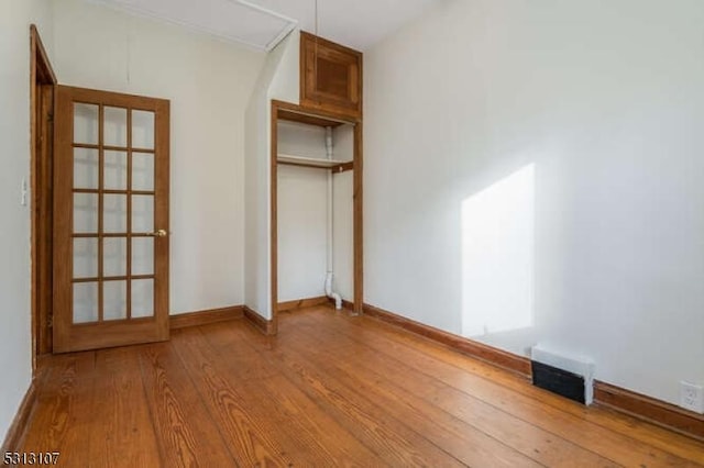 unfurnished bedroom with a closet and hardwood / wood-style floors