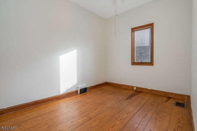 spare room featuring hardwood / wood-style floors