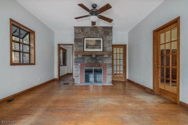 unfurnished living room with ceiling fan, a fireplace, french doors, and light hardwood / wood-style flooring