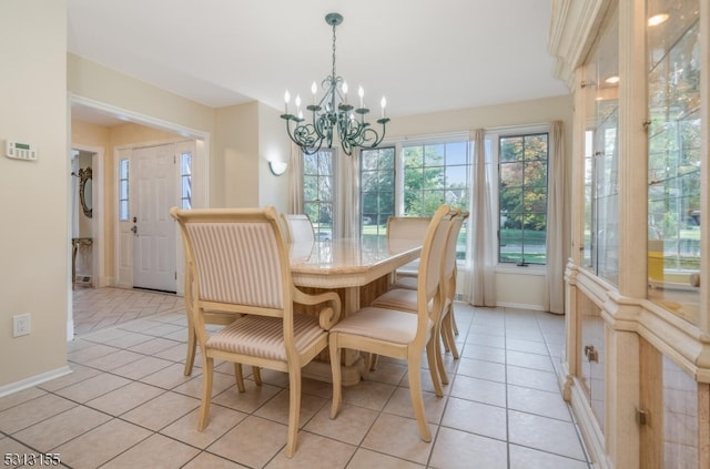 dining room with light tile patterned flooring and an inviting chandelier