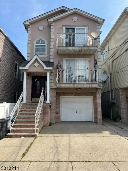 view of front of property with a balcony and a garage