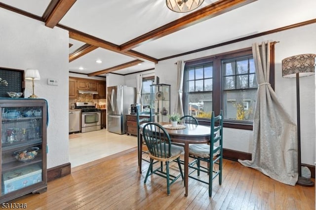 dining area with light wood-style floors, ornamental molding, beamed ceiling, and baseboards