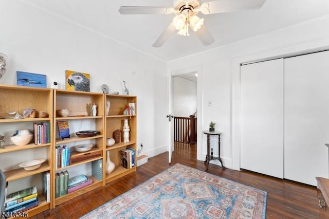 sitting room featuring wood finished floors, a ceiling fan, and baseboards