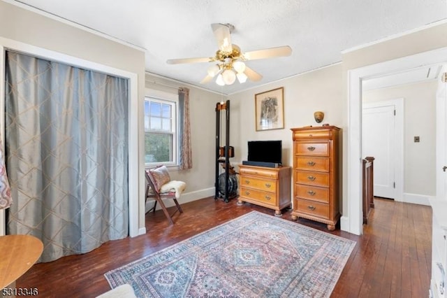 bedroom with ornamental molding, a ceiling fan, hardwood / wood-style flooring, and baseboards