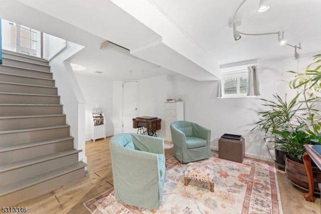 living room featuring stairway, wood finished floors, and baseboards