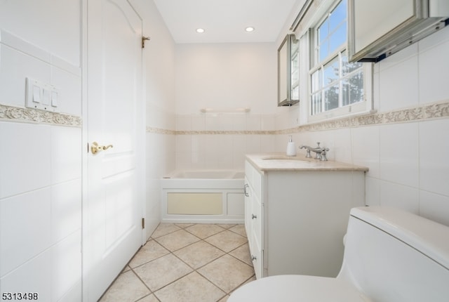 bathroom with tile walls, a bathing tub, and toilet