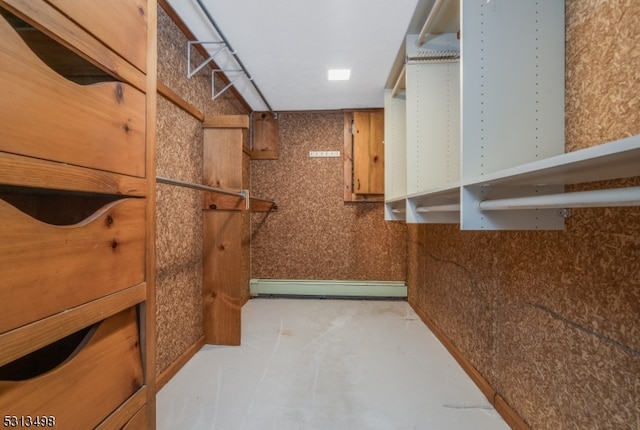 walk in closet featuring a baseboard heating unit