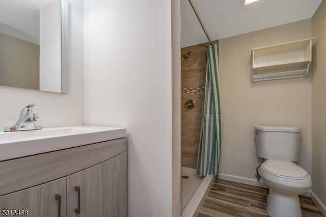 bathroom featuring a shower with curtain, hardwood / wood-style floors, vanity, and toilet