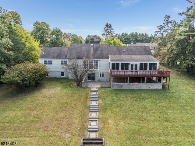 view of front of house featuring a deck and a front lawn