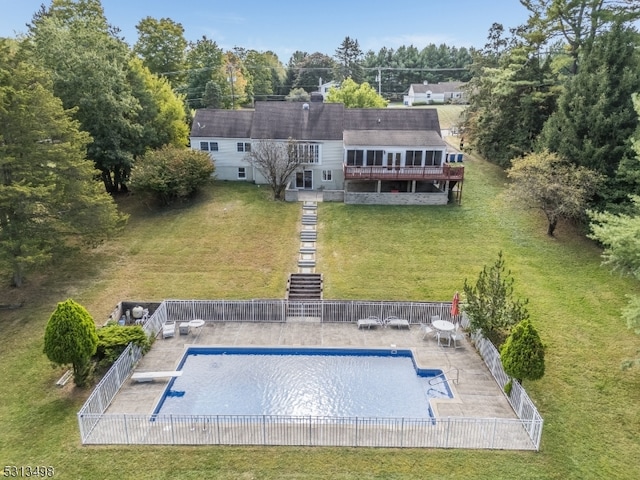 exterior space with a diving board and a yard