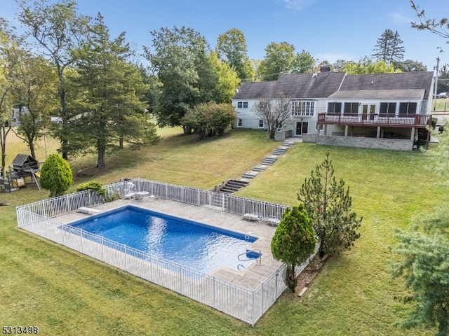 view of pool featuring a diving board, a yard, and a wooden deck