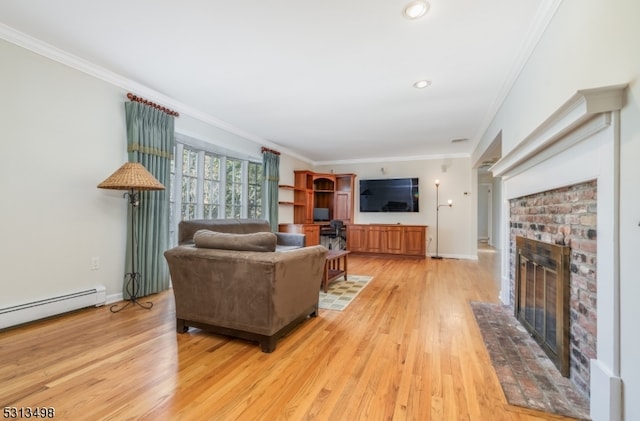 living room featuring a baseboard heating unit, a brick fireplace, light hardwood / wood-style floors, and crown molding