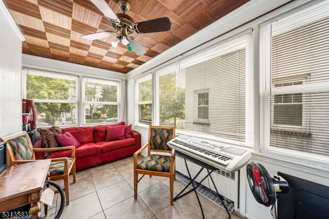 sunroom / solarium with wooden ceiling and ceiling fan