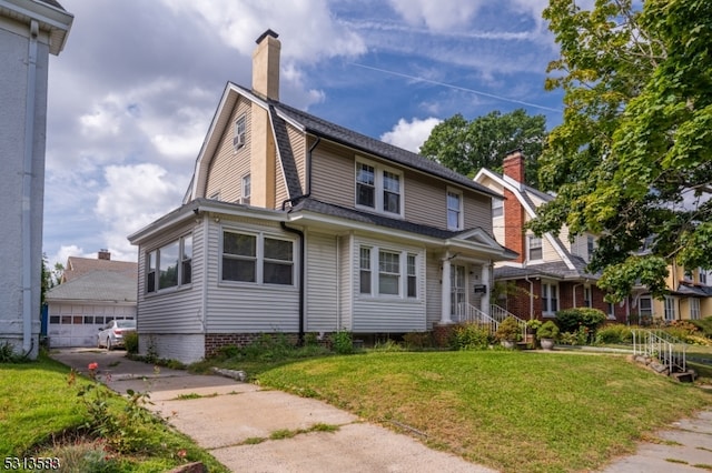 view of front of property with a front yard and a garage