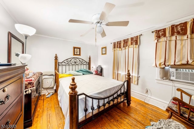 bedroom with ornamental molding, cooling unit, ceiling fan, and hardwood / wood-style floors