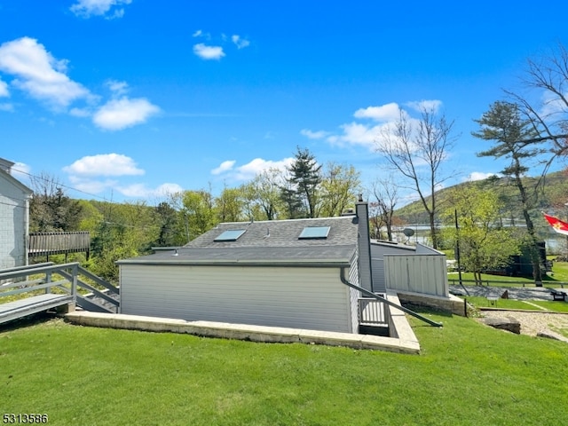 rear view of house featuring a yard