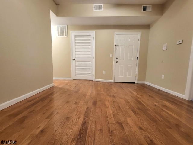 spare room featuring wood-type flooring