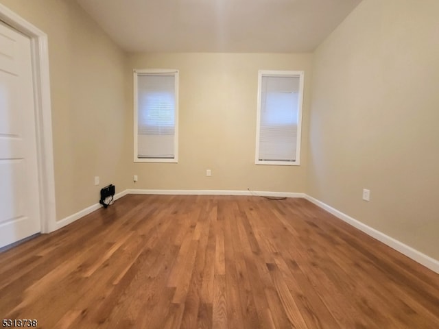 unfurnished room featuring wood-type flooring