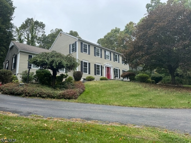 colonial-style house with a front yard