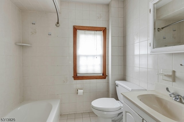 full bathroom featuring tiled shower / bath, vanity, toilet, tile walls, and tile patterned flooring