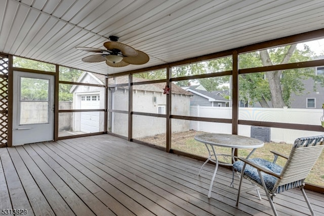 unfurnished sunroom with wood ceiling and ceiling fan