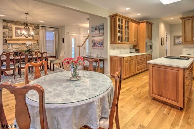 dining room with light hardwood / wood-style flooring and a chandelier