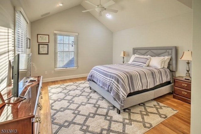 bedroom with light hardwood / wood-style flooring, ceiling fan, and lofted ceiling