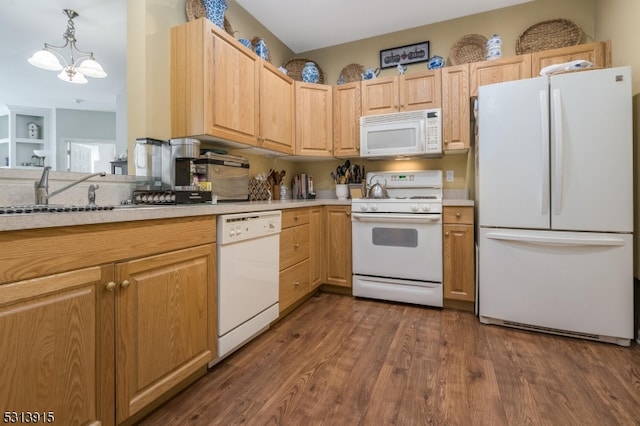 kitchen featuring white appliances, light brown cabinetry, hanging light fixtures, dark wood-type flooring, and a chandelier