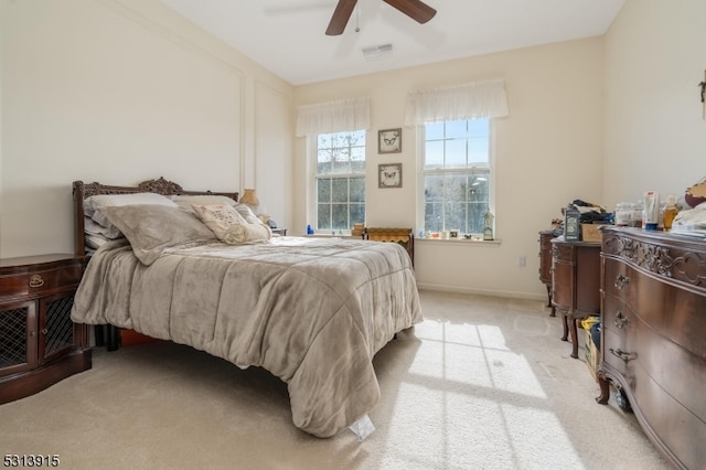 bedroom featuring light carpet and ceiling fan