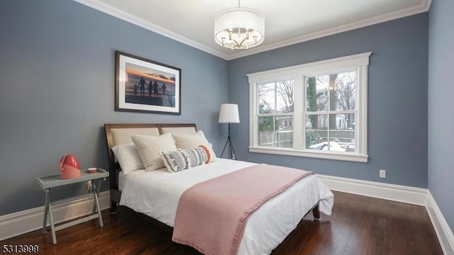 bedroom featuring dark wood-type flooring, crown molding, and an inviting chandelier