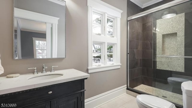 bathroom with crown molding, plenty of natural light, toilet, and vanity