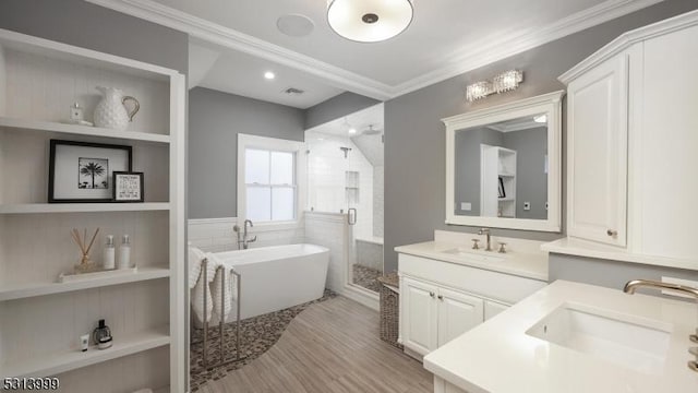 bathroom with crown molding, separate shower and tub, hardwood / wood-style flooring, and vanity