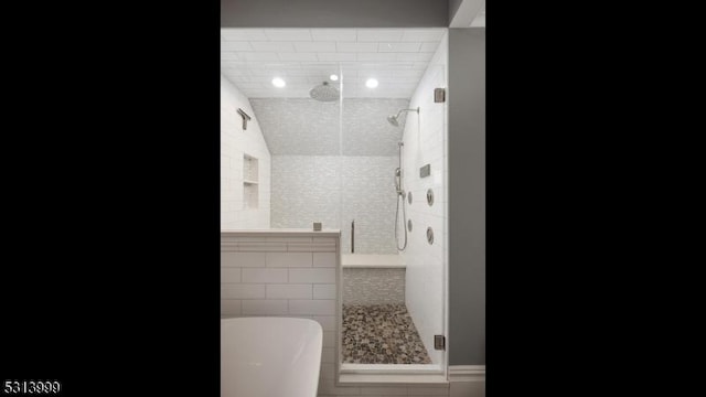 bathroom with vaulted ceiling and plus walk in shower