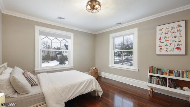 bedroom with crown molding and dark hardwood / wood-style floors