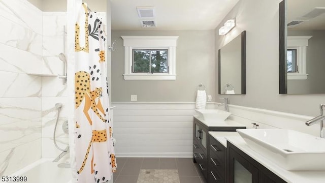 bathroom with vanity, tile patterned floors, and shower / bathtub combination with curtain