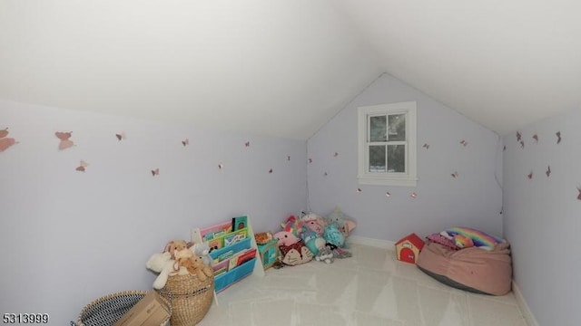 playroom with light carpet and vaulted ceiling