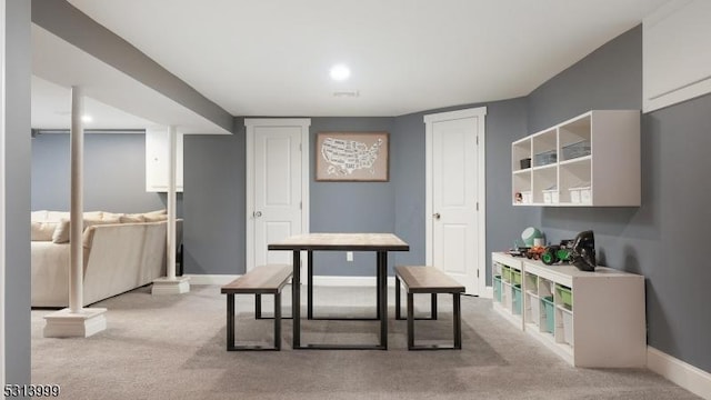 dining area featuring light colored carpet