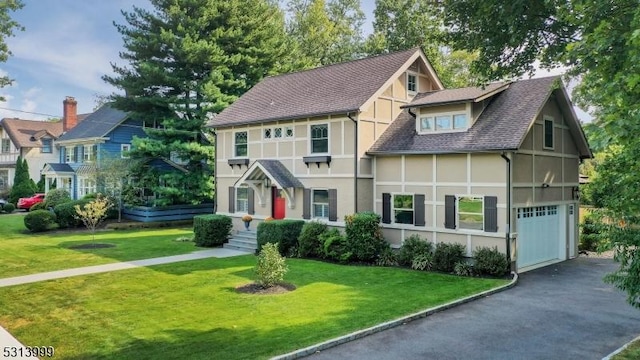 view of front of property with a front yard and a garage