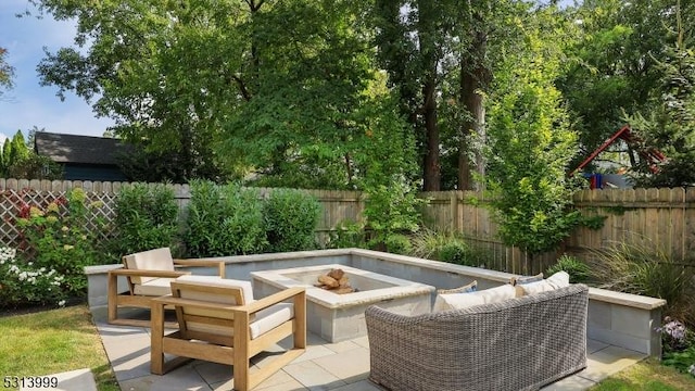 view of patio / terrace with an outdoor living space with a fire pit