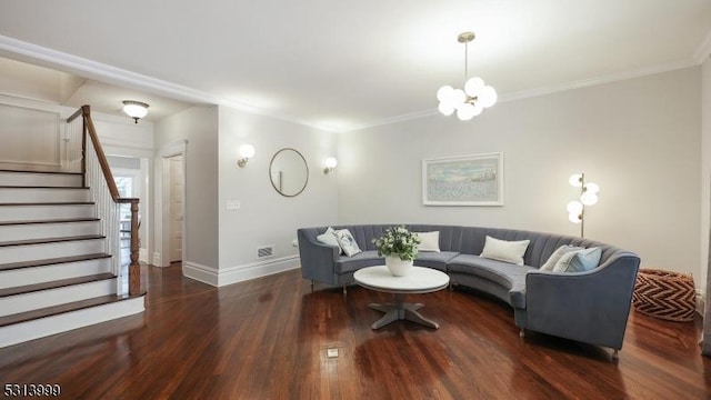 living room with dark wood-type flooring, a chandelier, and ornamental molding