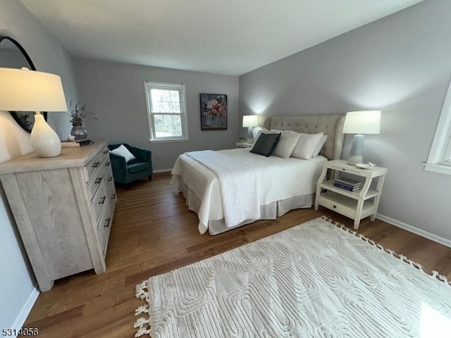 bedroom with light wood-style flooring and baseboards