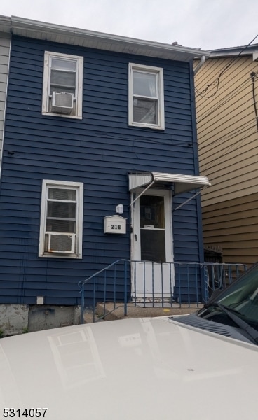 view of front of home featuring cooling unit