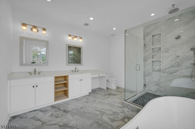 full bathroom featuring shower with separate bathtub, vanity, and toilet