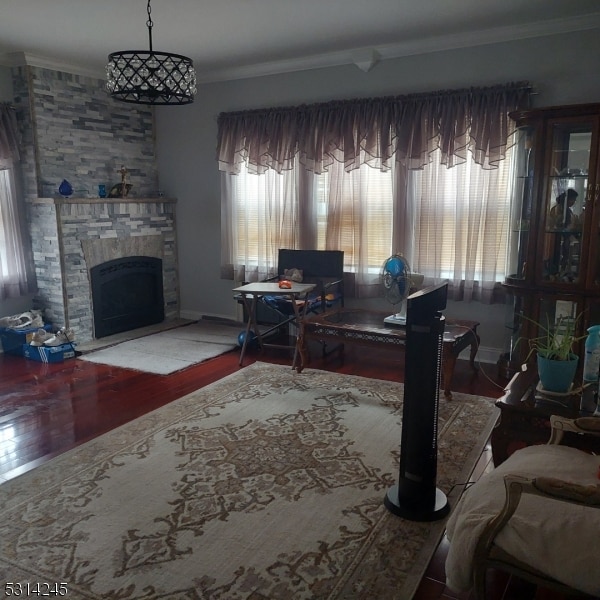 office featuring a stone fireplace, hardwood / wood-style flooring, plenty of natural light, and crown molding